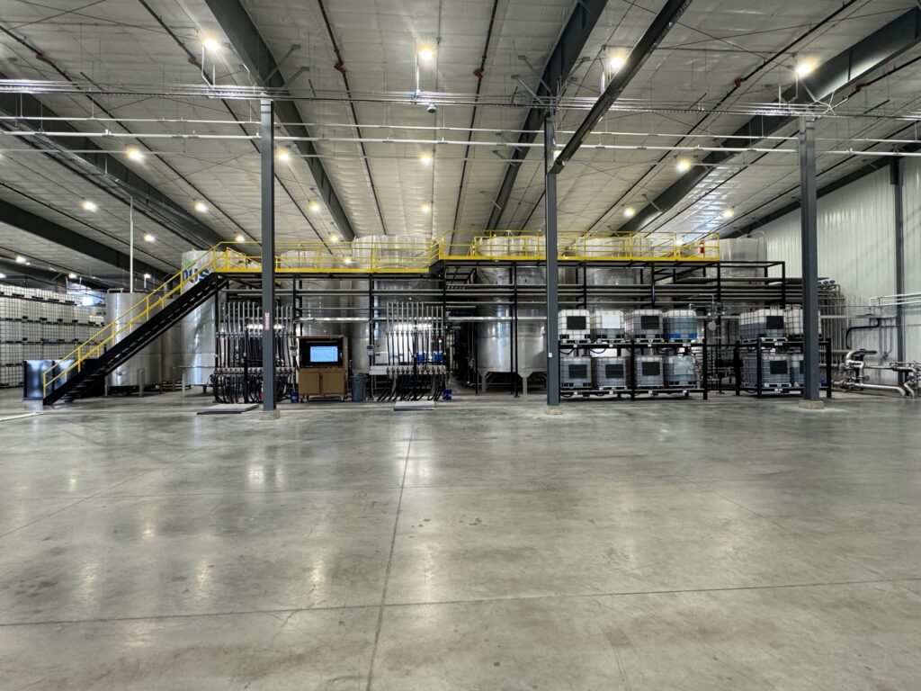 Storing ag chemicals and fertilizer in large storage tanks with steel building and concrete floor