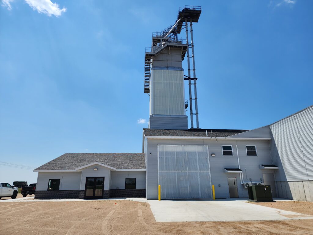 Fertilizer blend tower on a dry plant food building and storage building with bi-fold door closed and office