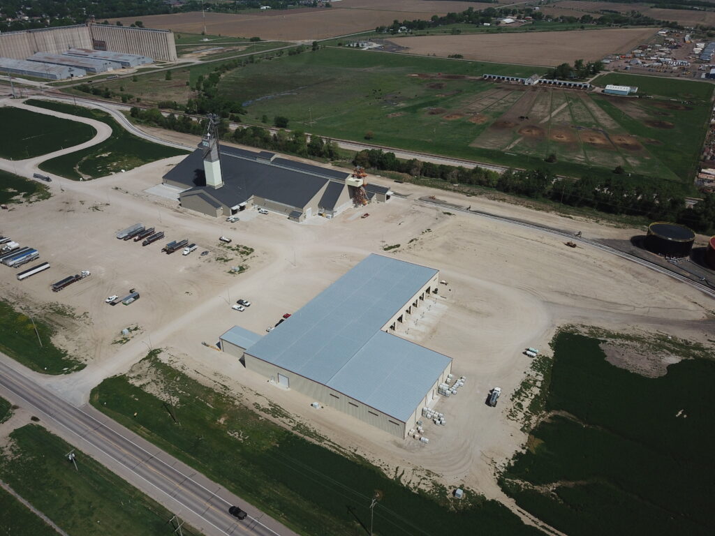 Large Dry Fertilizer blending and storage facility and Liquid fertilizer building from Stueve Construction along a rail siding in nebraska
