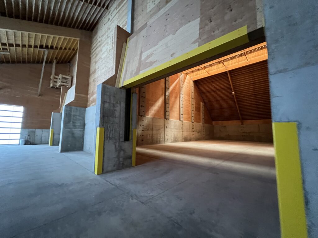 Empty Fertilizer storage bin can hold tons for crop nutrients with yellow imbedded corners