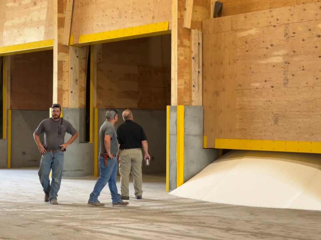 Men working inside a dry fertilizer building