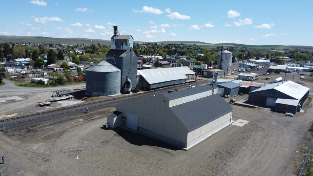 dry fertilizer storage building with feed mill along railroad tracks