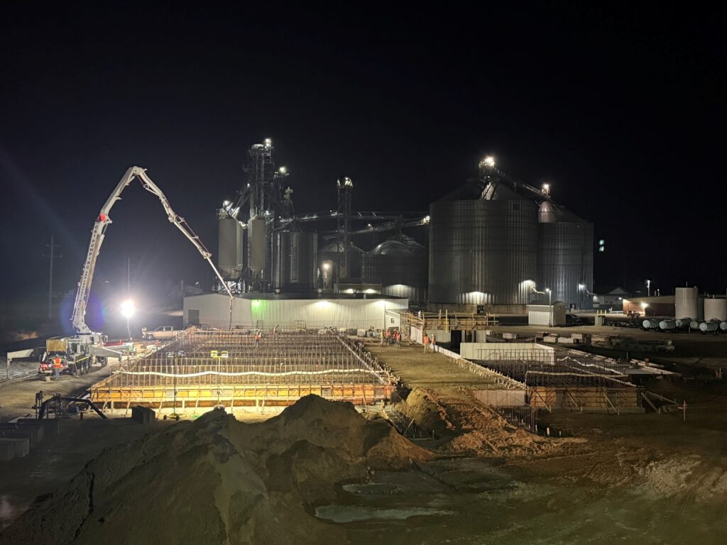 dry fertilizer storage building under construction at night
